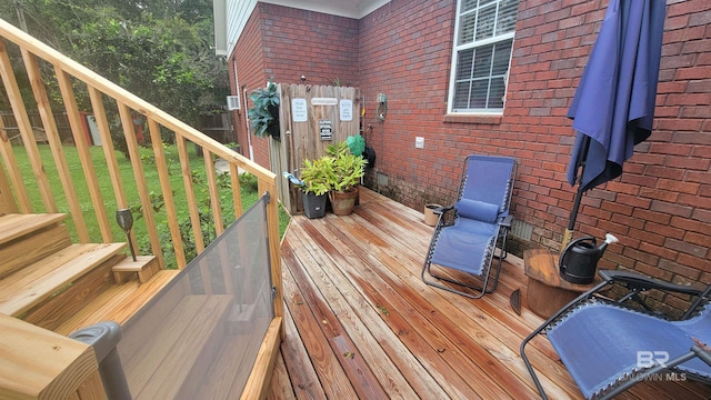 wooden terrace with a lawn