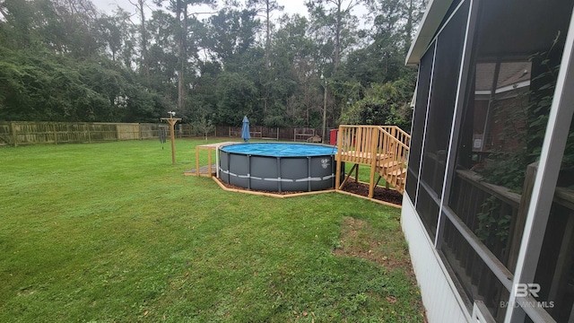 view of yard with a fenced in pool