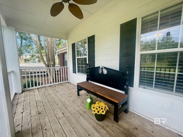 deck featuring covered porch and ceiling fan