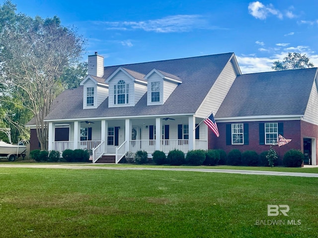 new england style home featuring a porch and a front yard