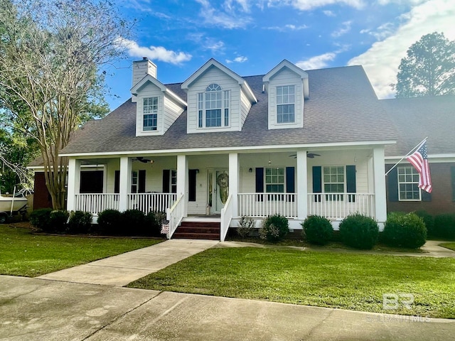 cape cod home featuring a front yard and a porch