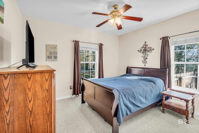 bedroom featuring light carpet and ceiling fan