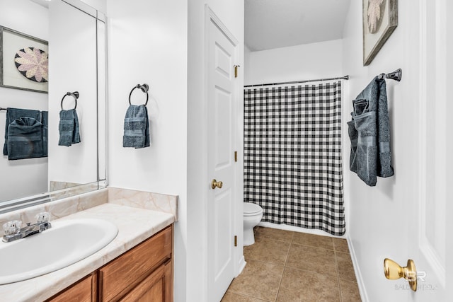 bathroom with tile patterned floors, a shower with curtain, vanity, and toilet