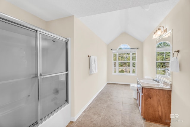 full bathroom featuring tile patterned floors, vanity, a textured ceiling, vaulted ceiling, and toilet