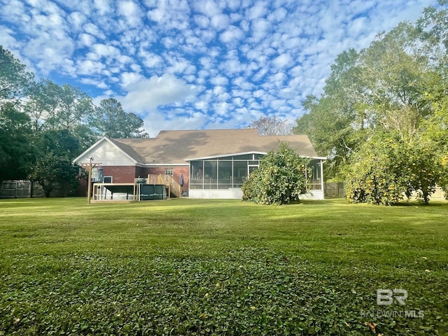 view of yard with a sunroom