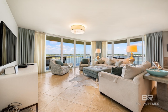 tiled living room featuring expansive windows and a water view