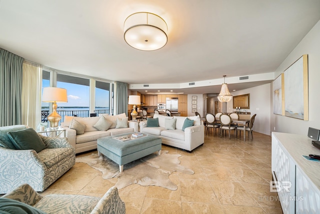 living room featuring a water view and floor to ceiling windows