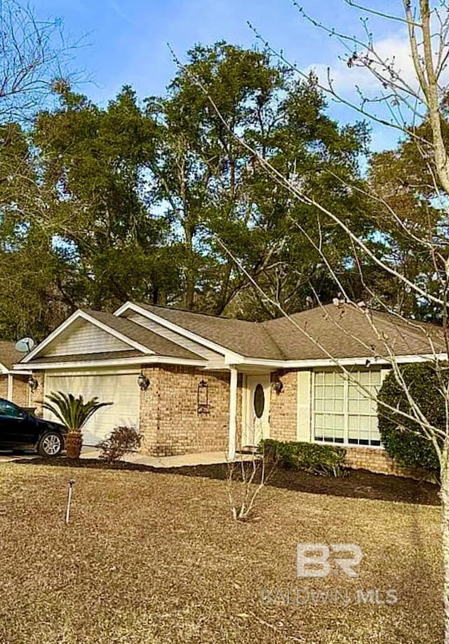 ranch-style house featuring brick siding and an attached garage