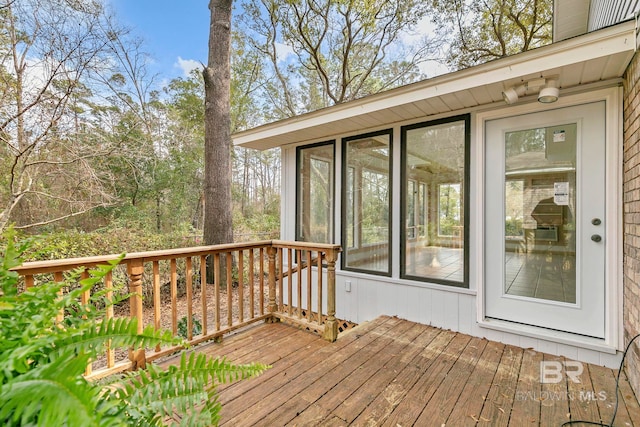 wooden deck with a sunroom