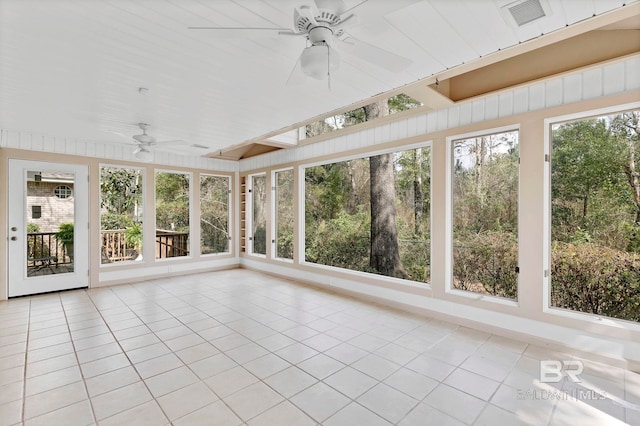 unfurnished sunroom featuring visible vents, a wealth of natural light, and a ceiling fan