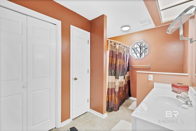 bathroom with tile patterned flooring, vanity, baseboards, a closet, and a shower with curtain