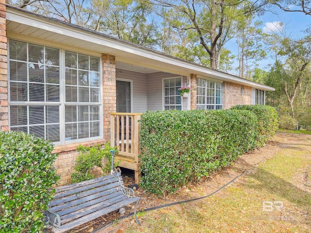 doorway to property with brick siding