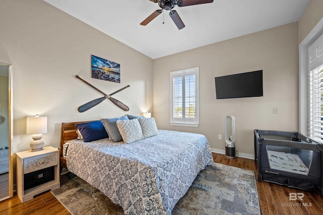 bedroom with ceiling fan, lofted ceiling, and dark hardwood / wood-style floors