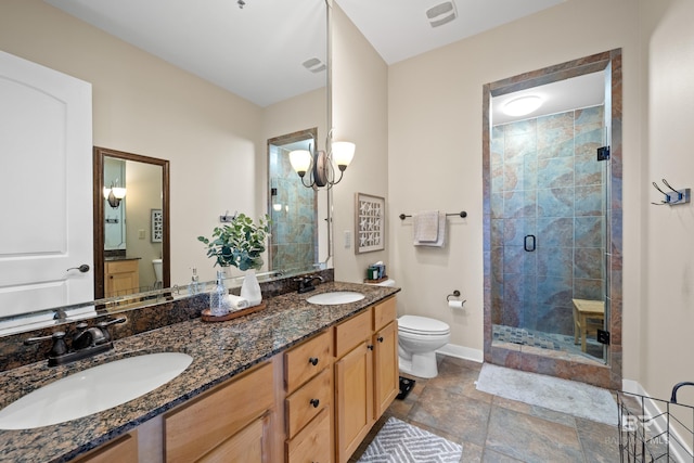 bathroom with vanity, a notable chandelier, toilet, and walk in shower