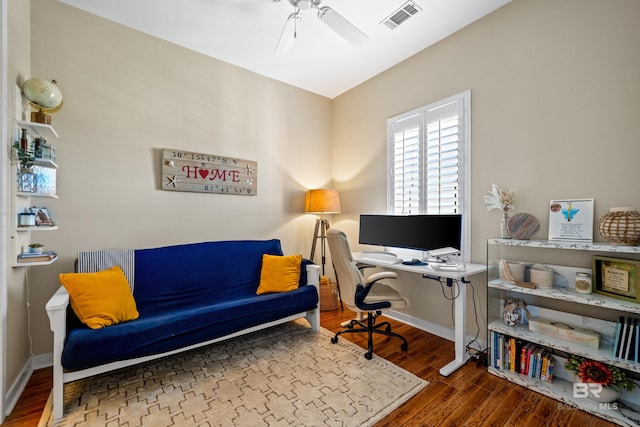 home office with dark wood-type flooring and ceiling fan