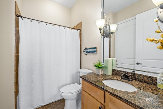 bathroom with toilet, curtained shower, vanity, and tile patterned flooring