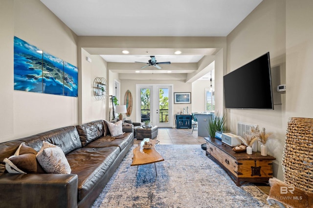 living room featuring ceiling fan and light tile patterned floors