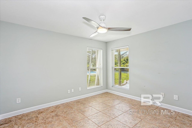 5553 Ponte Verde Rd, Pensacola, FL 32507 - spare room featuring light tile patterned floors, baseboards, and ceiling fan