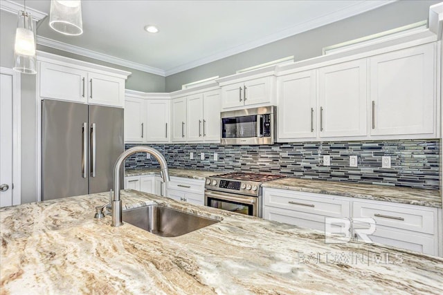 5553 Ponte Verde Rd, Pensacola, FL 32507 - kitchen featuring decorative backsplash, appliances with stainless steel finishes, hanging light fixtures, a sink, and white cabinets