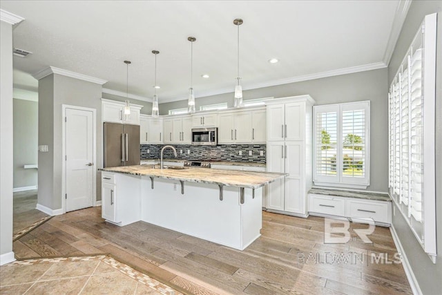 5553 Ponte Verde Rd, Pensacola, FL 32507 - kitchen with white cabinets, appliances with stainless steel finishes, a sink, and light wood-type flooring