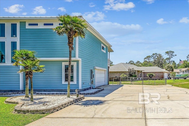 5553 Ponte Verde Rd, Pensacola, FL 32507 - view of side of property with a garage, fence, and driveway
