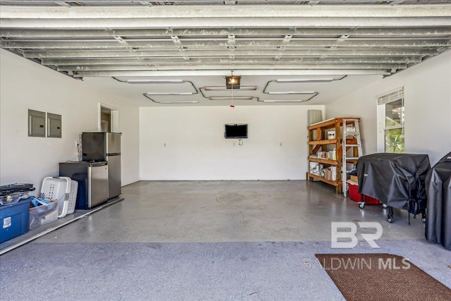 5553 Ponte Verde Rd, Pensacola, FL 32507 - garage featuring a garage door opener, electric panel, and freestanding refrigerator