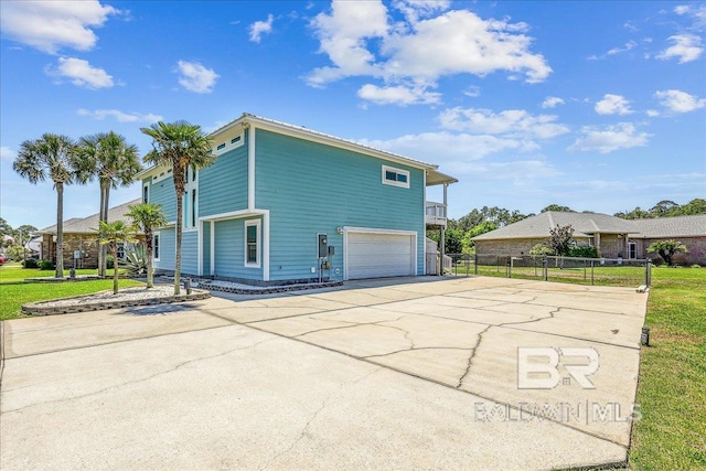 5553 Ponte Verde Rd, Pensacola, FL 32507 - view of property exterior featuring an attached garage, fence, and driveway