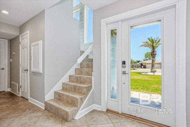 5553 Ponte Verde Rd, Pensacola, FL 32507 - entryway with stairway, baseboards, light tile patterned floors, and visible vents