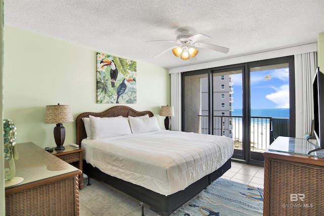 24522 Perdido Beach Blvd Unit 4909, Orange Beach, AL 36561 - bedroom with light tile patterned floors, access to exterior, ceiling fan, and a textured ceiling