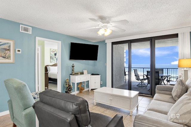 24522 Perdido Beach Blvd Unit 4909, Orange Beach, AL 36561 - living room featuring a ceiling fan, light tile patterned floors, and a textured ceiling