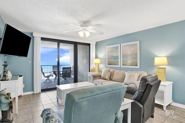 24522 Perdido Beach Blvd Unit 4909, Orange Beach, AL 36561 - living area featuring ceiling fan, light tile patterned floors, and a textured ceiling