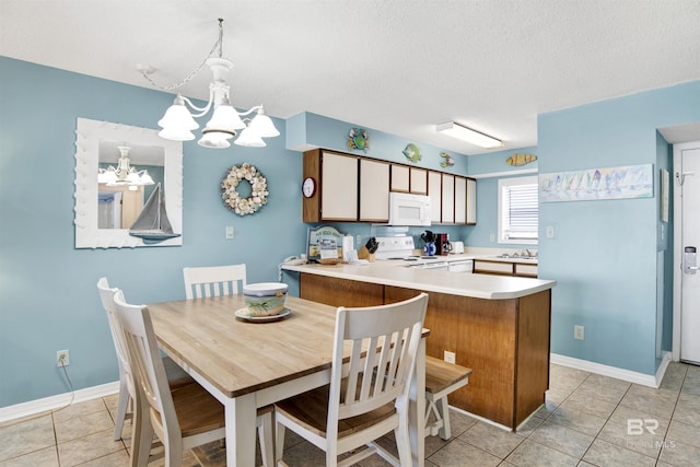 24522 Perdido Beach Blvd Unit 4909, Orange Beach, AL 36561 - dining space featuring a chandelier, light tile patterned floors, and a textured ceiling