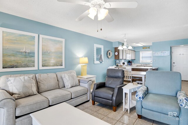 24522 Perdido Beach Blvd Unit 4909, Orange Beach, AL 36561 - living area with light tile patterned floors, ceiling fan, a chandelier, and a textured ceiling