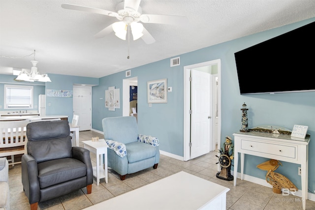 24522 Perdido Beach Blvd Unit 4909, Orange Beach, AL 36561 - living area featuring a chandelier, light tile patterned floors, a textured ceiling, and ceiling fan