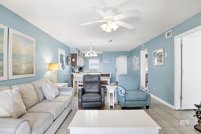 24522 Perdido Beach Blvd Unit 4909, Orange Beach, AL 36561 - living area featuring ceiling fan, a chandelier, light tile patterned floors, and a textured ceiling