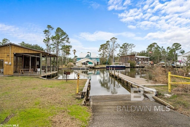 view of dock featuring a water view and a yard