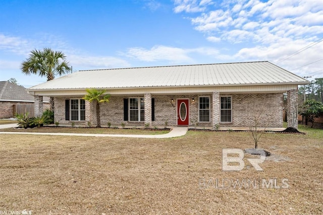 ranch-style home featuring covered porch, a front lawn, metal roof, and brick siding