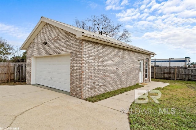 view of property exterior with driveway, an attached garage, fence, and brick siding