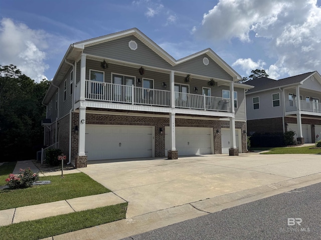 6811 Spaniel Dr Unit C, Spanish Fort, AL 36527 - view of front of home with an attached garage, brick siding, and concrete driveway