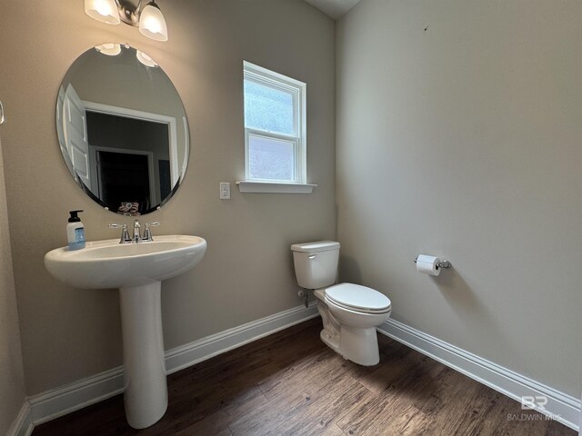 6811 Spaniel Dr Unit C, Spanish Fort, AL 36527 - bathroom with baseboards, toilet, and wood finished floors