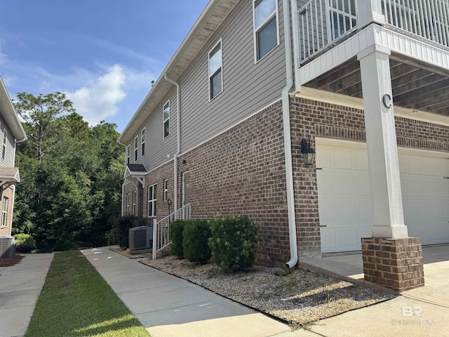 6811 Spaniel Dr Unit C, Spanish Fort, AL 36527 - view of home's exterior featuring brick siding, an attached garage, a balcony, and central AC unit