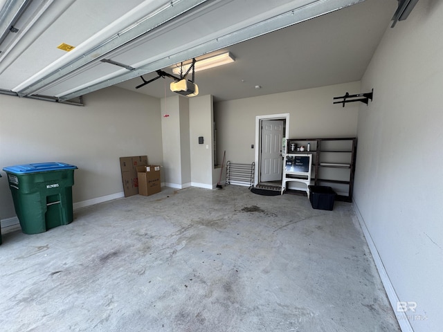 6811 Spaniel Dr Unit C, Spanish Fort, AL 36527 - garage featuring a garage door opener and baseboards
