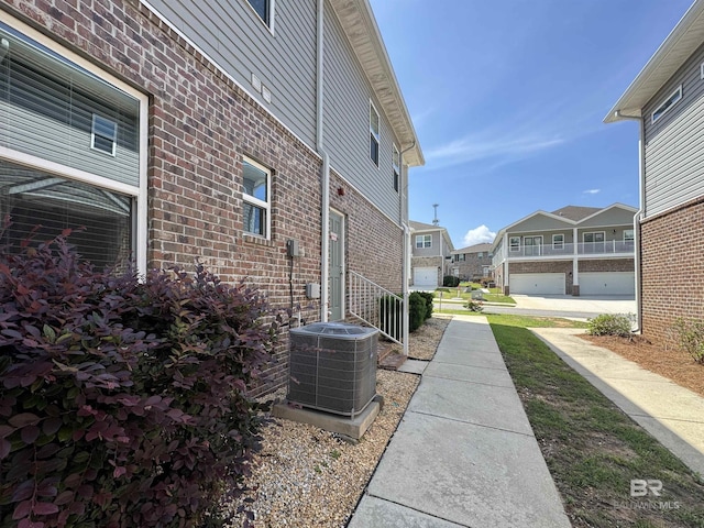 6811 Spaniel Dr Unit C, Spanish Fort, AL 36527 - view of side of property featuring central AC unit, brick siding, and a residential view