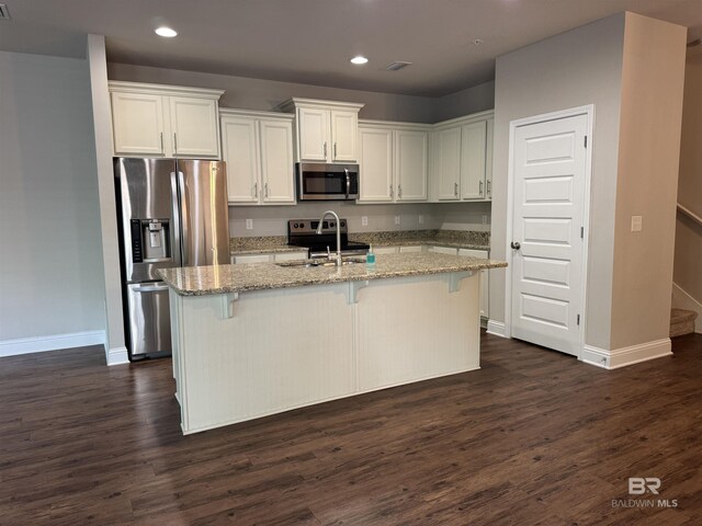 6811 Spaniel Dr Unit C, Spanish Fort, AL 36527 - kitchen featuring appliances with stainless steel finishes, recessed lighting, baseboards, light stone counters, and white cabinets