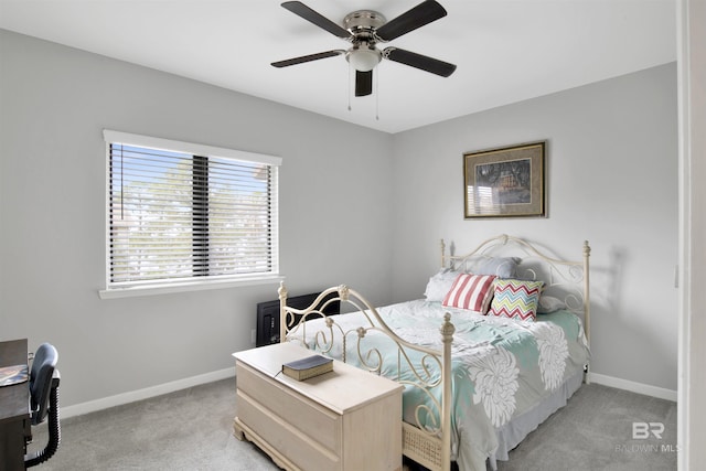 bedroom featuring light carpet, ceiling fan, and baseboards