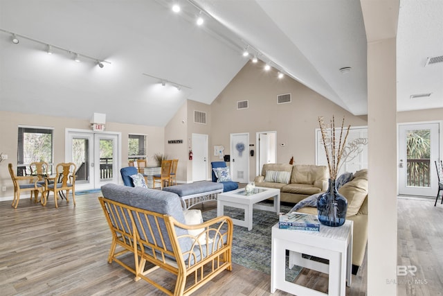 living area with french doors, visible vents, and light wood-style floors