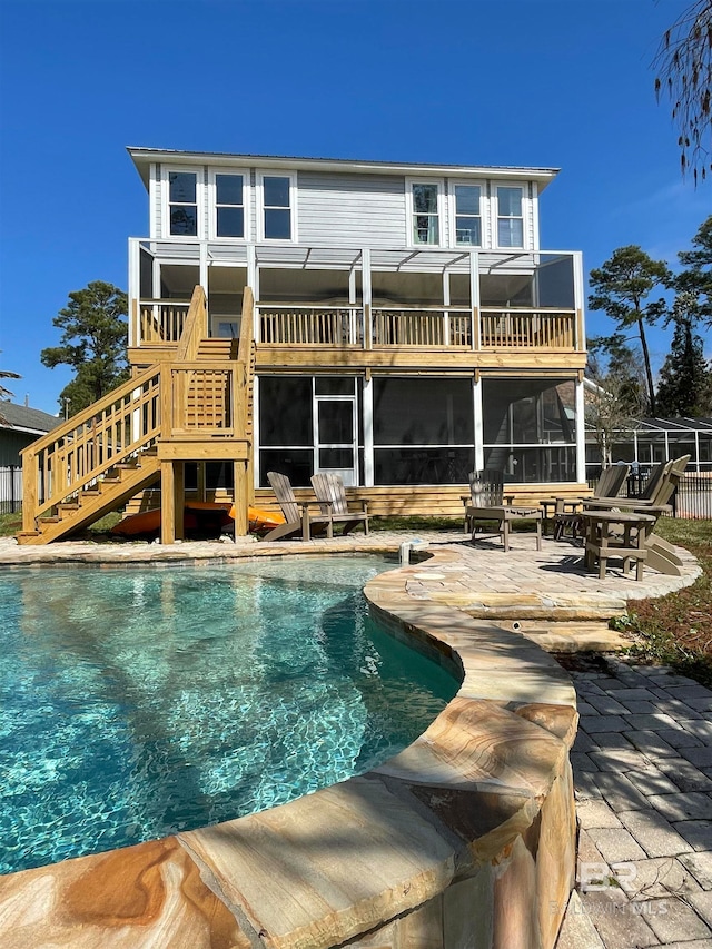 back of house with a sunroom and a patio