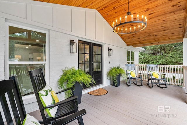 wooden deck with covered porch and french doors