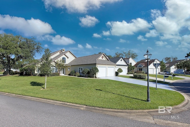 view of front of home with a front yard and a garage