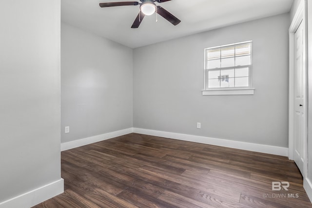 spare room featuring ceiling fan and dark hardwood / wood-style floors